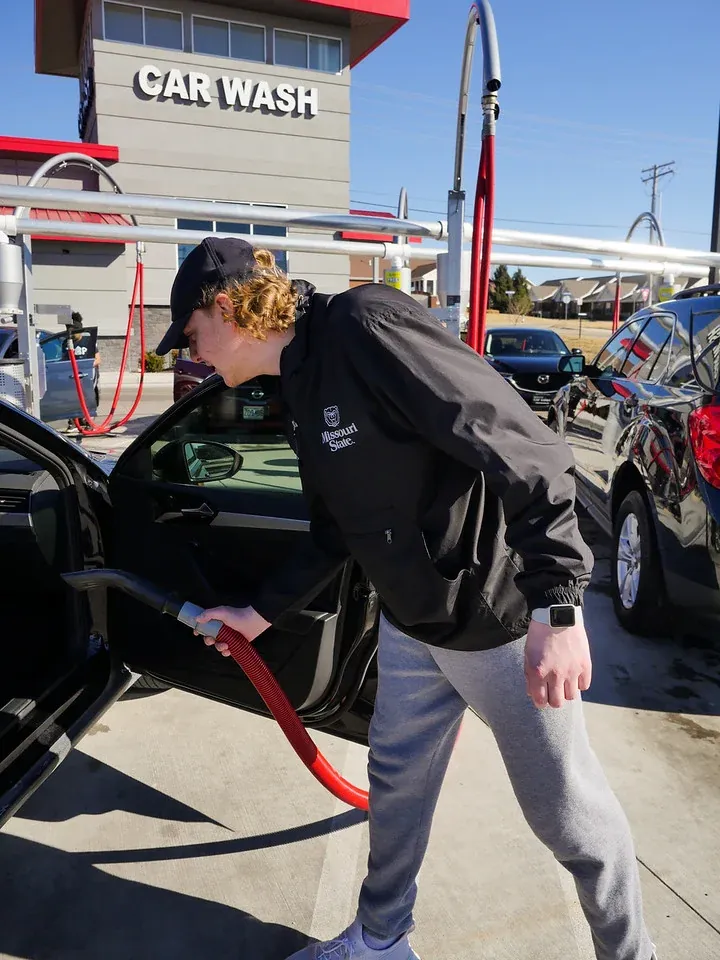 A Soapify customer vacuuming out his car with the free self-serve vacuums in St. Peters